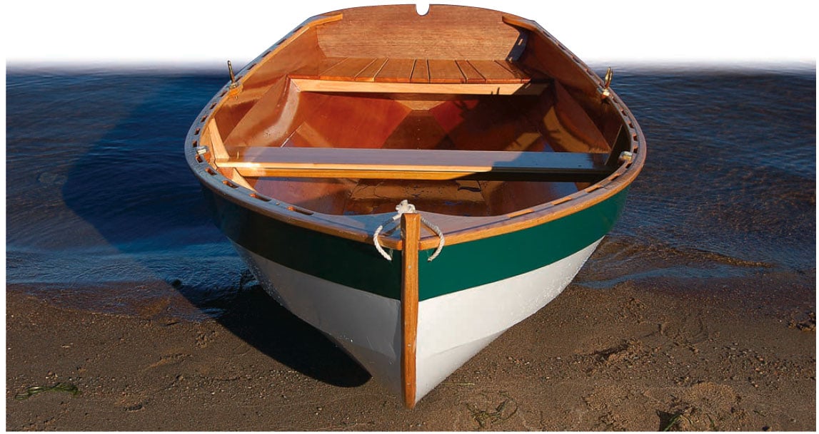 Shellback dinghy rowboat on a sandy shore.
